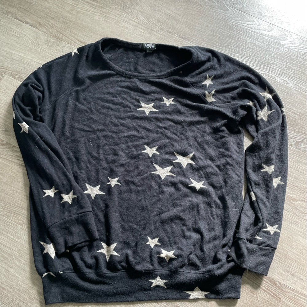 Longer black sweater with white stars.